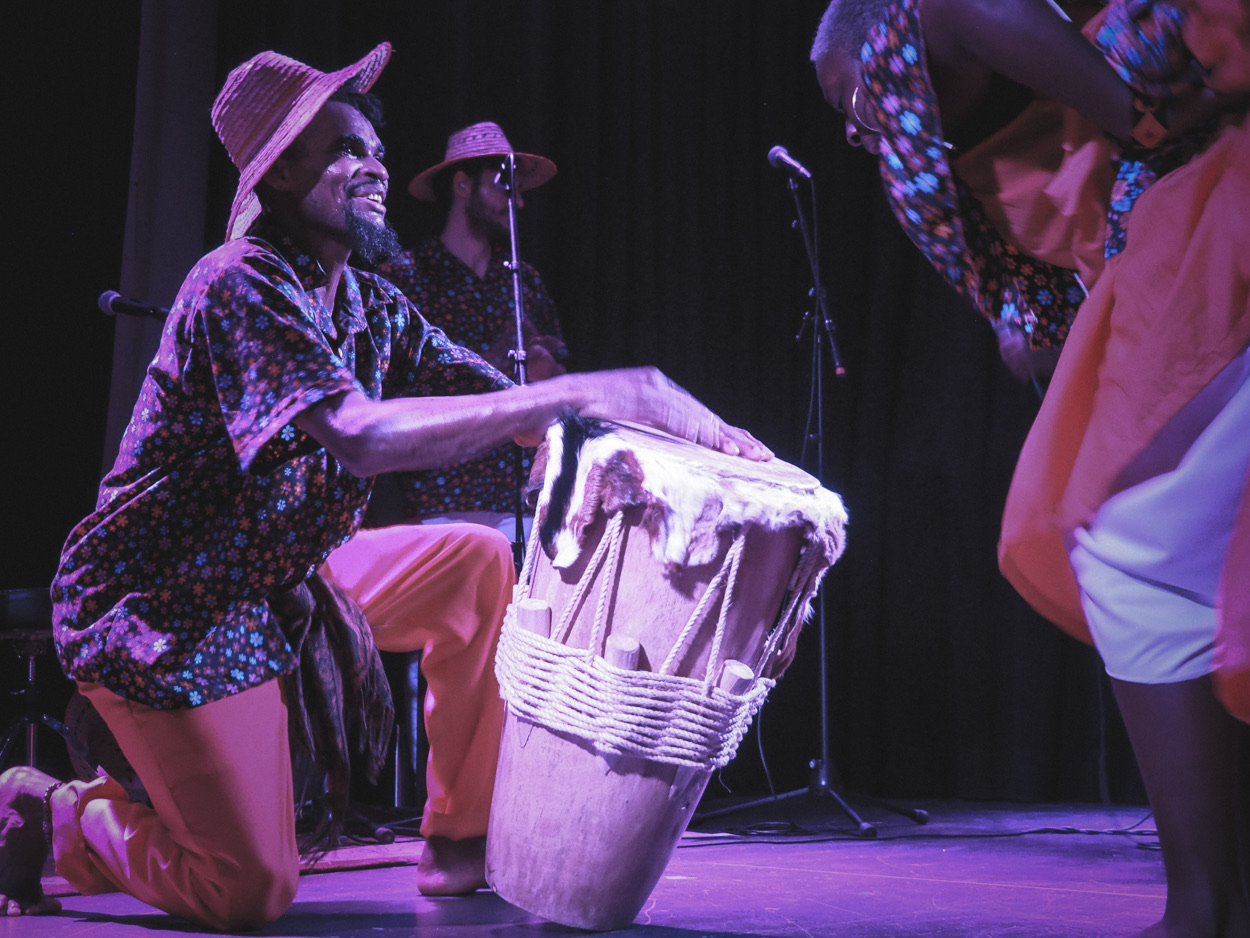 A bullerengue drummer and dancers performing on stage